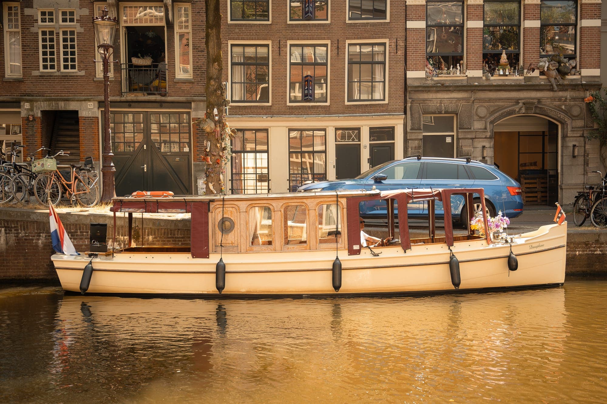 The Dauphine moored in front of the canal houses in evening light