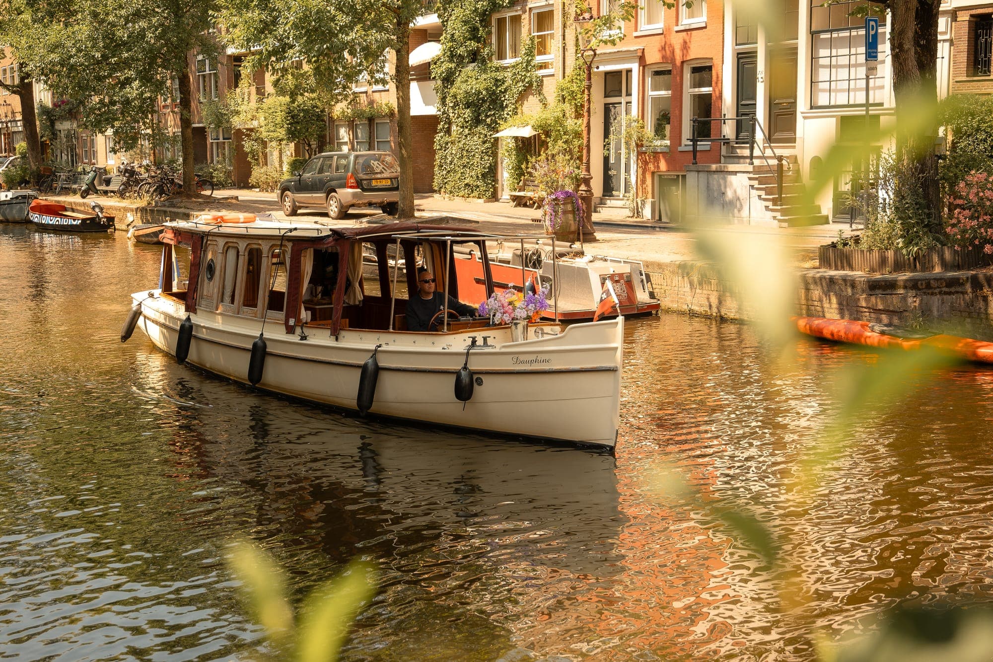 The Dauphine on a summery canal surrounded by greenery